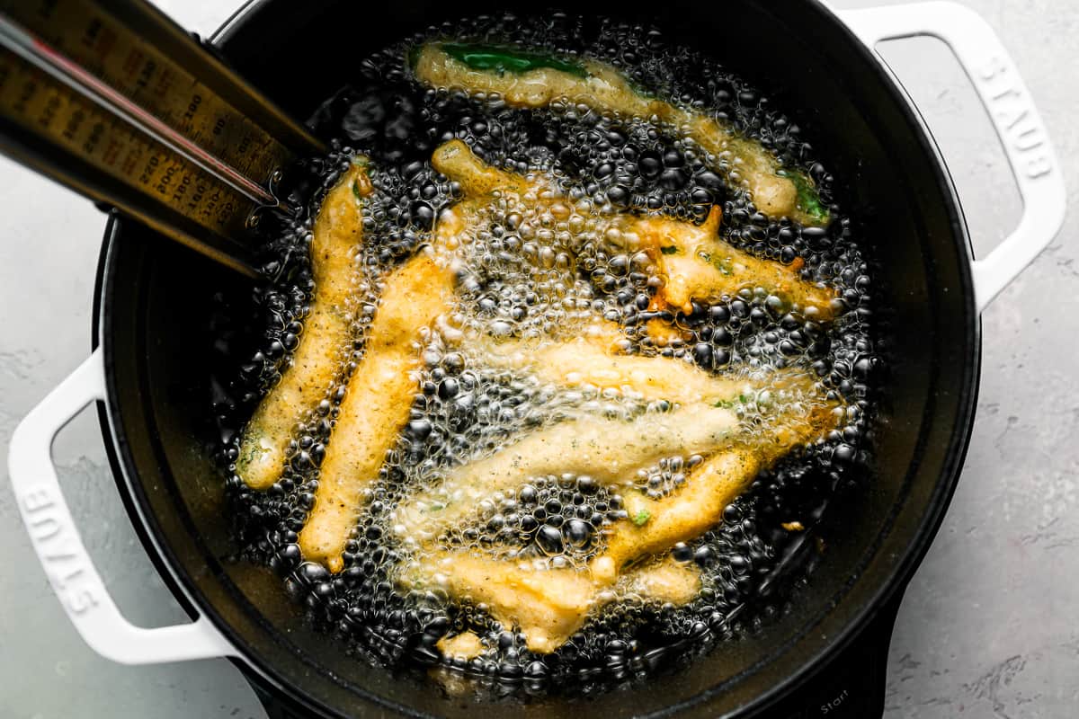 A pan filled with fried vegetables and a measuring tool.