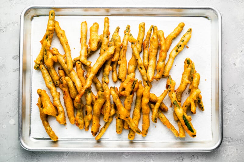 A tray of fried carrots on a table.