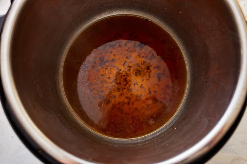 A close up of a brown liquid in an instant pot.