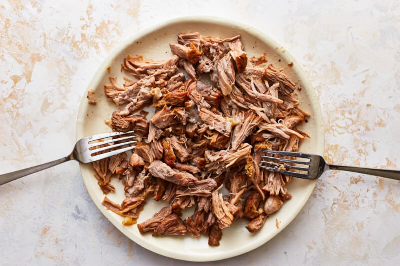 Pulled pork on a plate with forks.