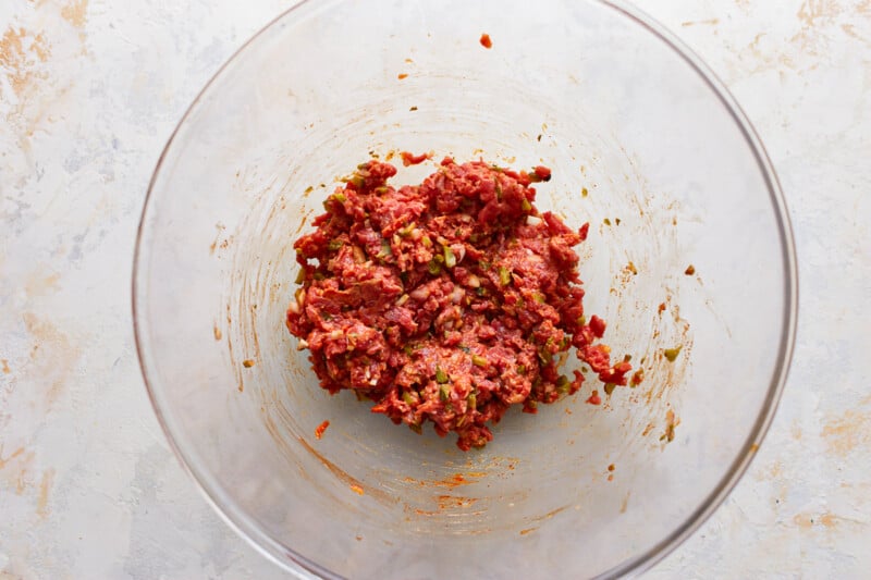 A bowl filled with meat and spices.