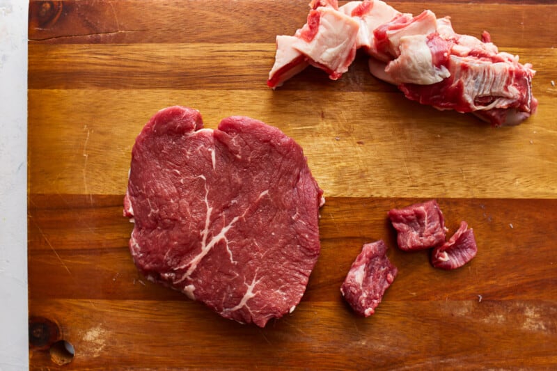 A piece of meat on a cutting board.