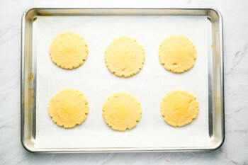 Cookies on a baking sheet on a marble countertop.