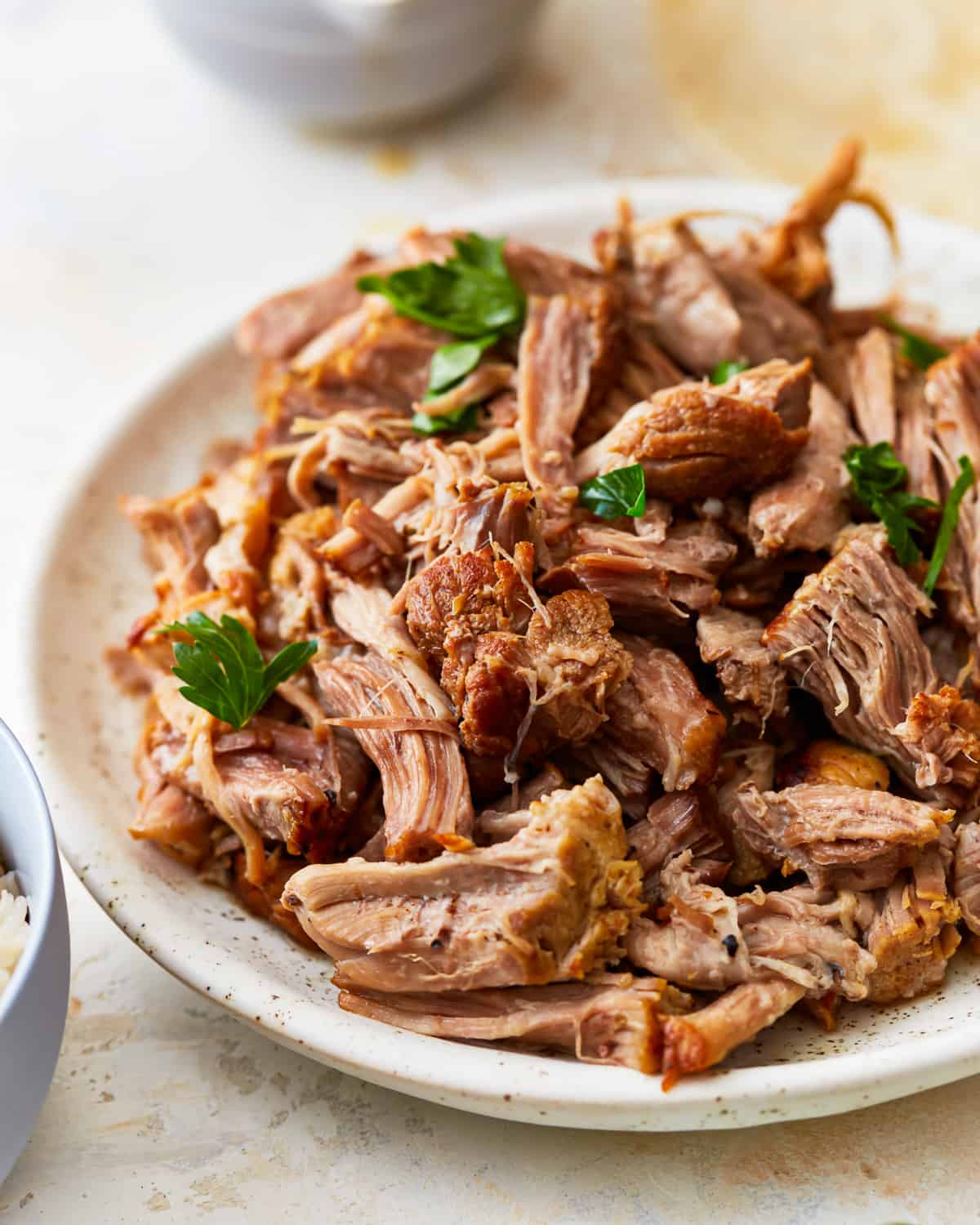 Shredded Instant pot pork shoulder on a plate.