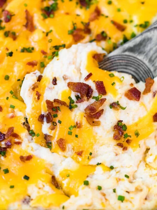 spoon digging into loaded mashed potato casserole