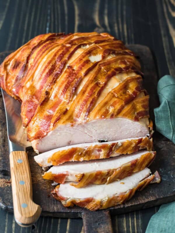 bacon wrapped turkey breast on cutting board