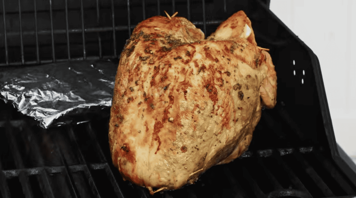 smoked turkey breast on a grill.