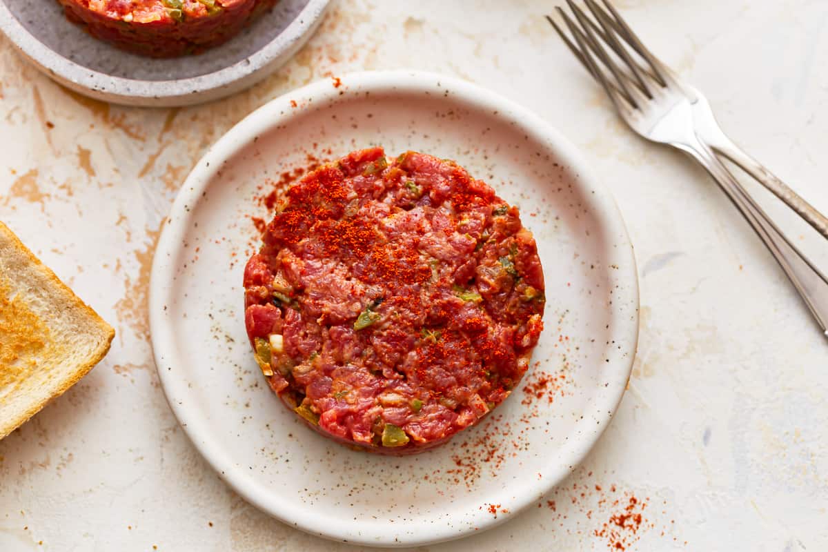 Meatballs on a plate with bread and a fork.