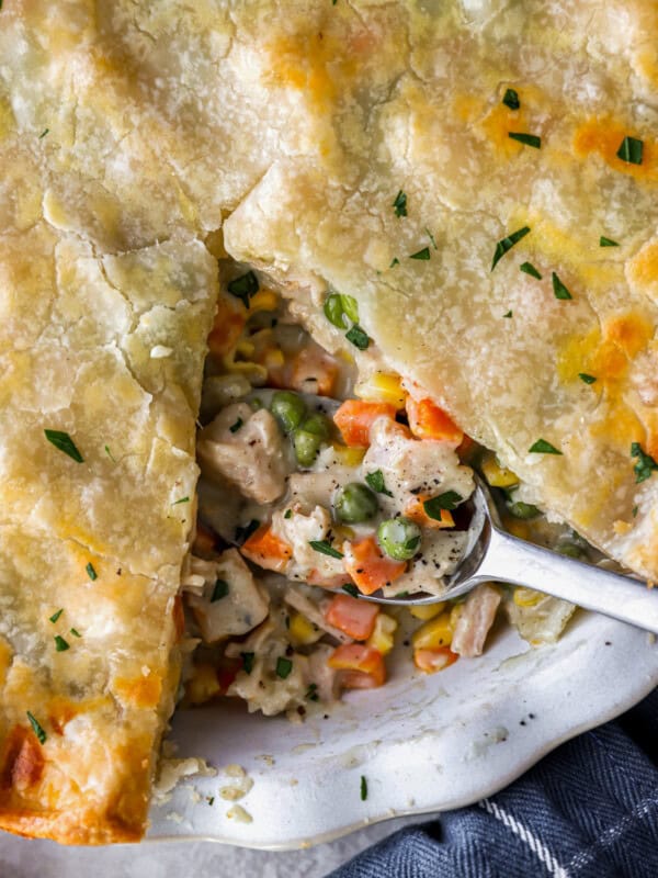 Turkey pot pie on a white plate with a spoon.