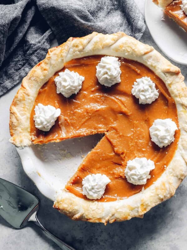 overhead view of a caramel pie with one slice removed