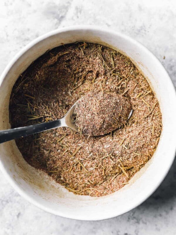 turkey rub in a white bowl with a spoon.