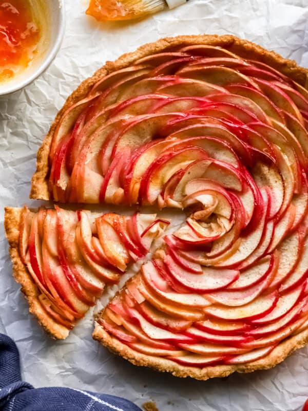 A slice of apple tart on a piece of paper.