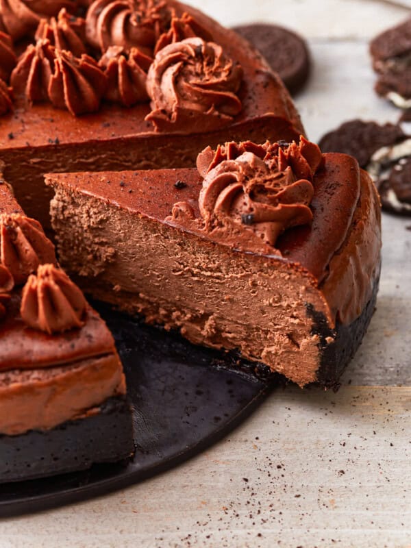 A chocolate cheesecake with a slice taken out.