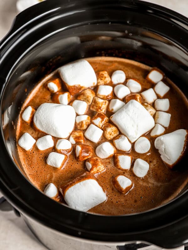 A crock pot filled with chocolate and marshmallows.