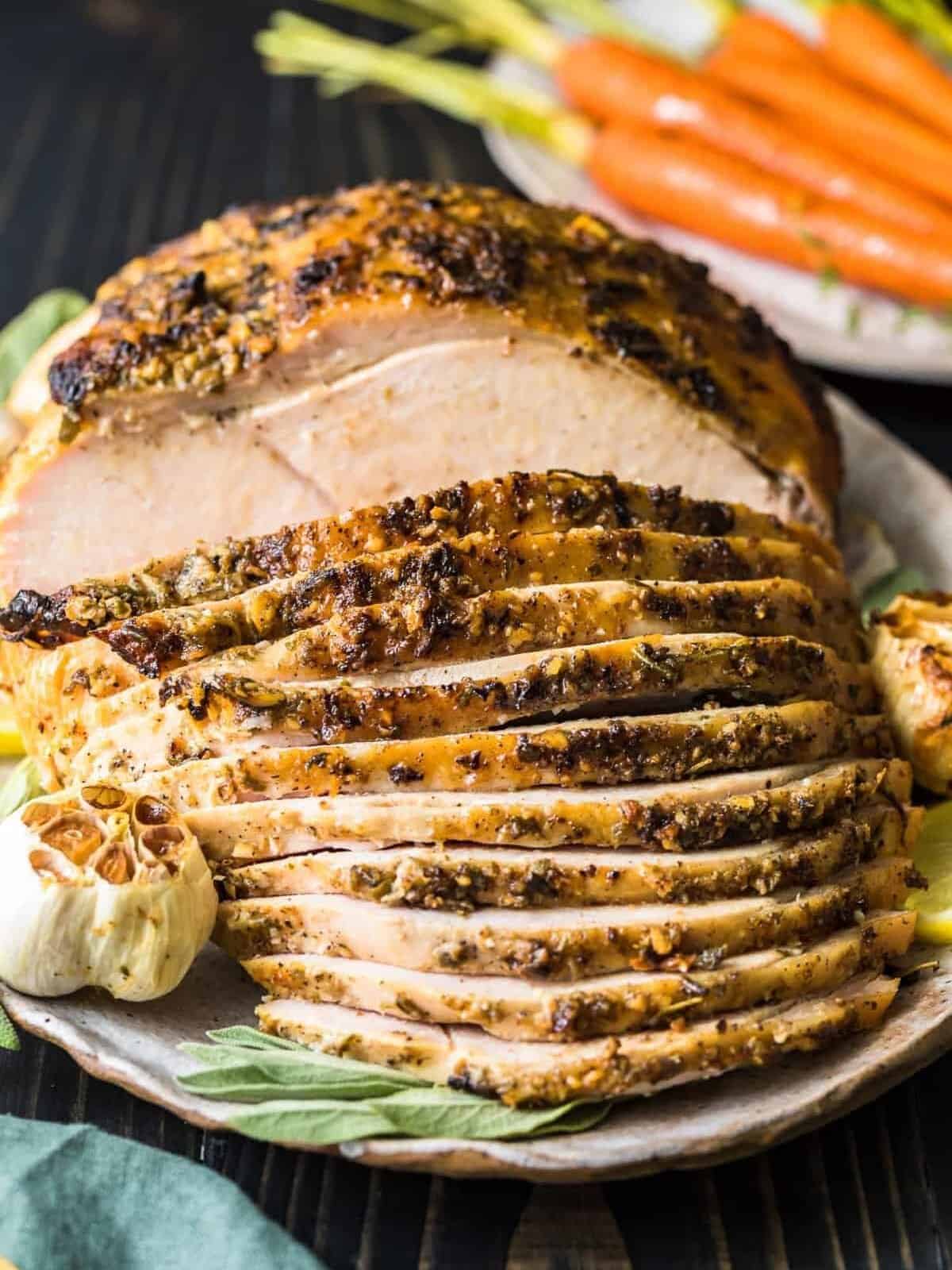 https://www.thecookierookie.com/wp-content/uploads/2023/11/garlic-butter-roast-turkey-recipe-turkey-with-40-cloves-1-of-8-edited.jpg