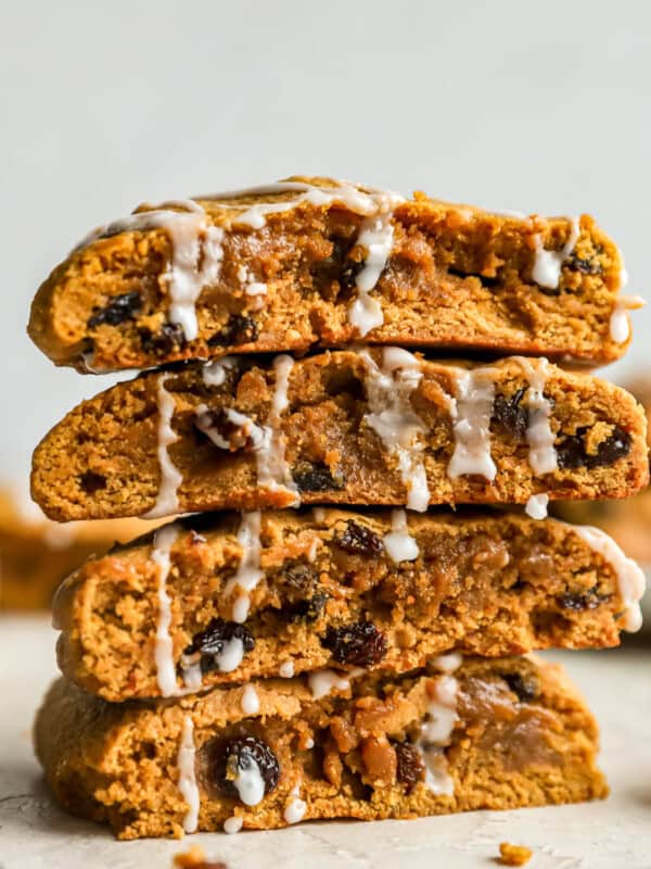 A stack of pumpkin raisin cookies with icing.