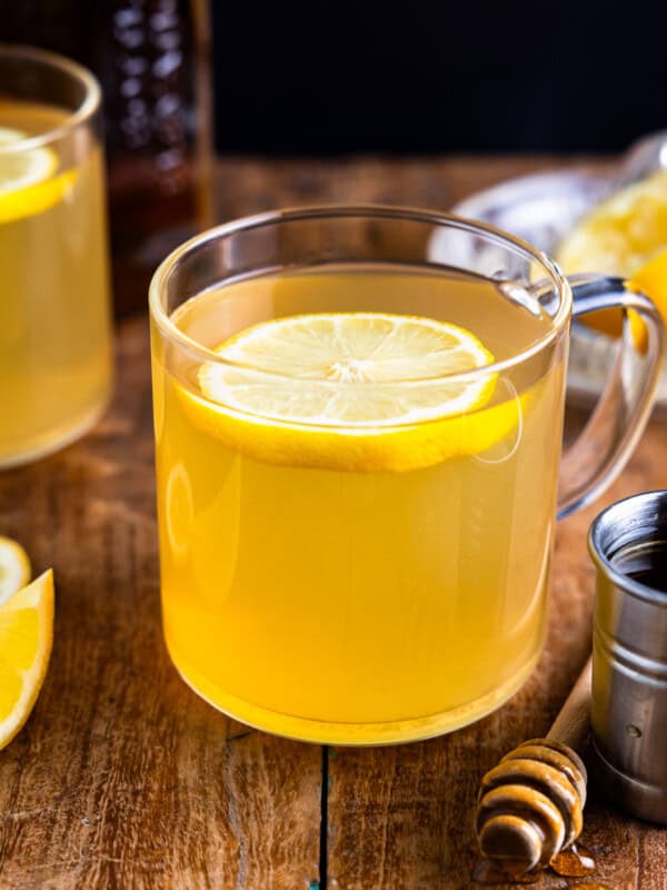 A cup of lemon tea with a slice of lemon.