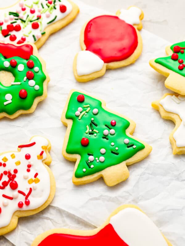 A bunch of decorated christmas cookies on a piece of paper.