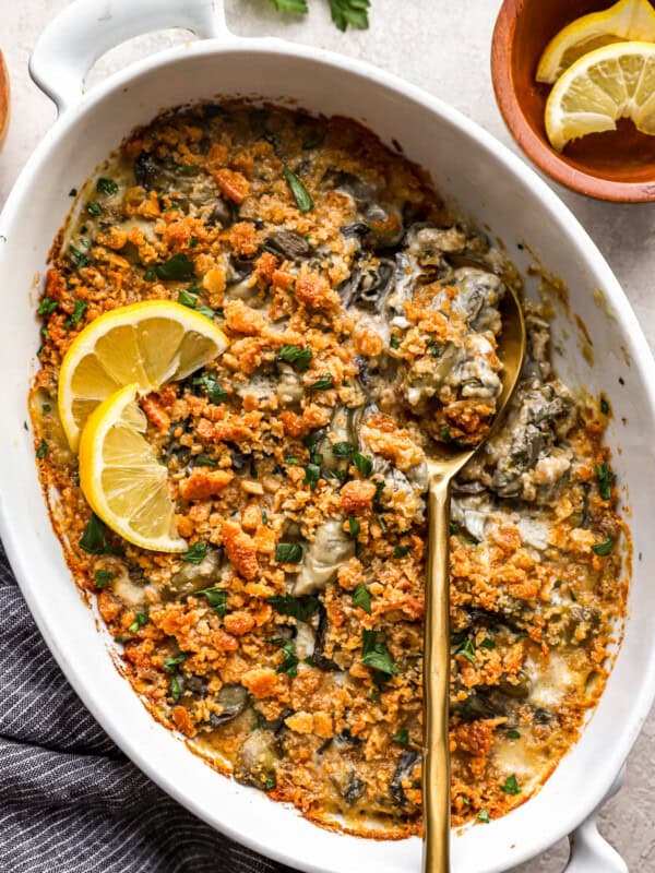 A dish of spinach and artichoke dip with a spoon.