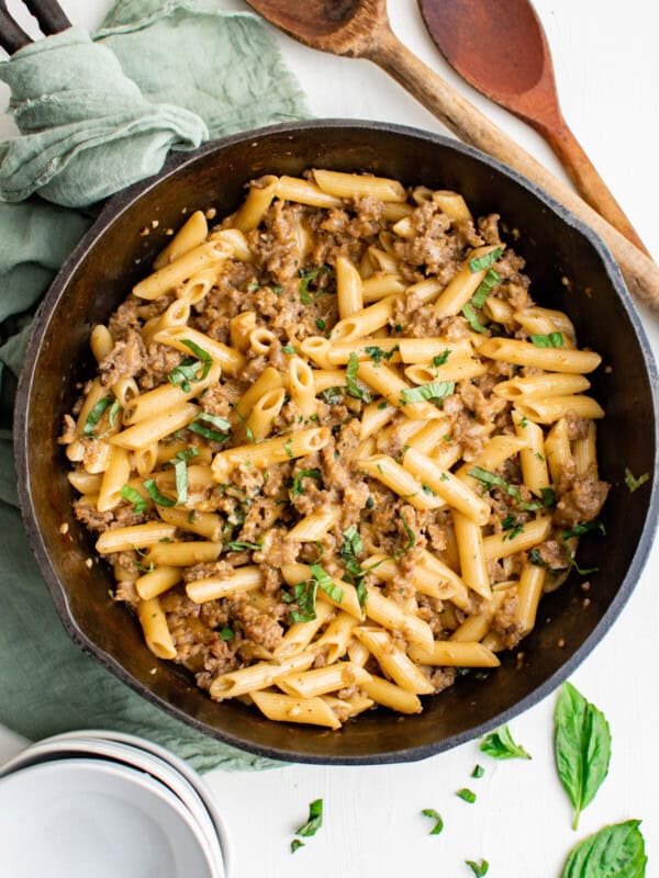 overhead view of sausage pasta in a cast iron pan.