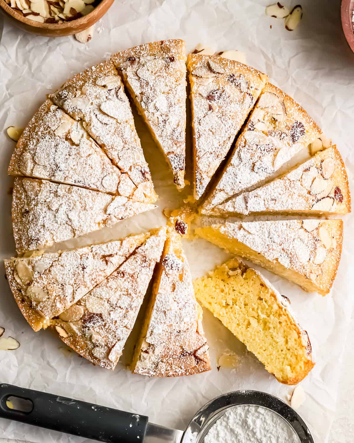 A moist almond cake topped with a delicate dusting of powdered sugar.