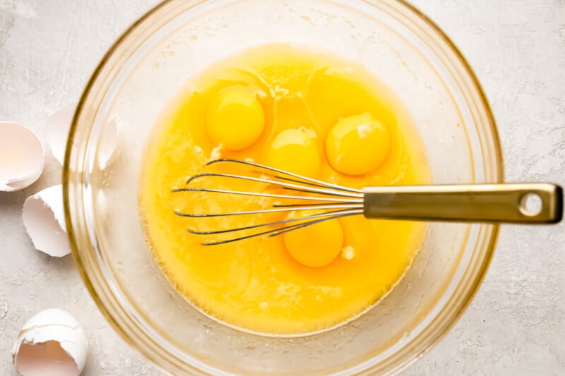 Whisking eggs in a bowl for an almond cake.