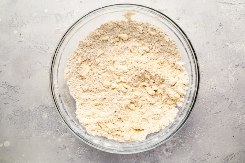 A glass bowl with flour in it, ready for making apple cobbler.