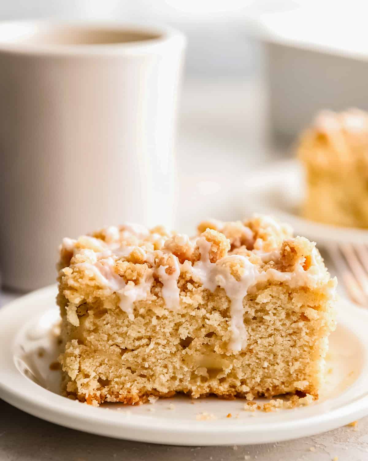 Up-close side view of a piece of coffee cake on a plate.