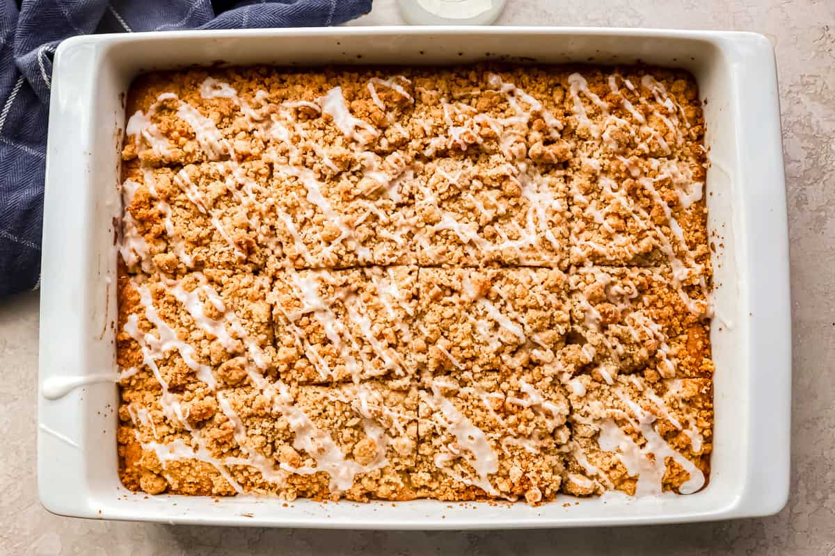 Baked apple coffee cake in a white baking dish.