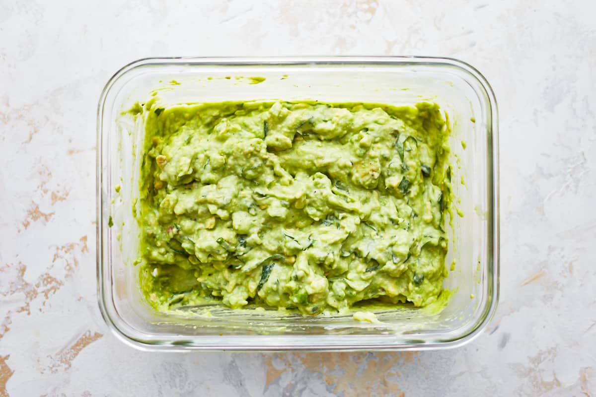 Avocado guacamole in a glass bowl.