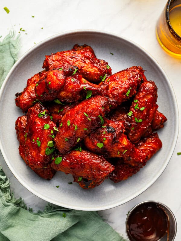 BBQ chicken wings served on a white plate.