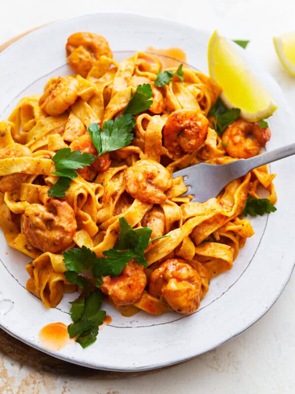 A plate of blackened shrimp alfredo pasta.