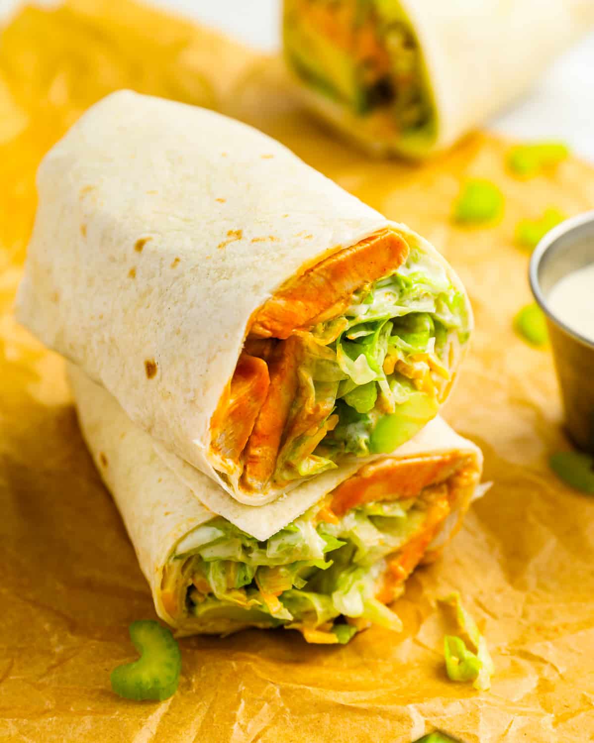 Two halves of a buffalo ranch chicken wrap stacked on top of each other.