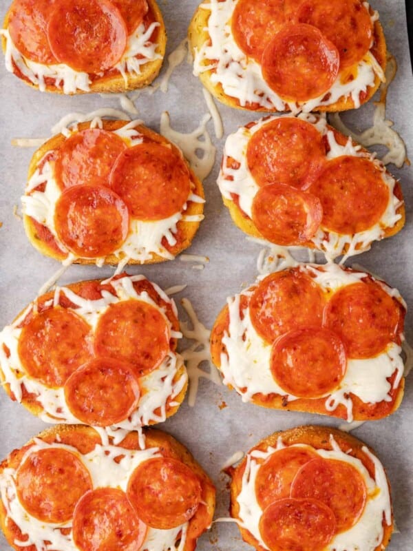 overhead view of 8 slices of texas toast pizza on parchment paper.