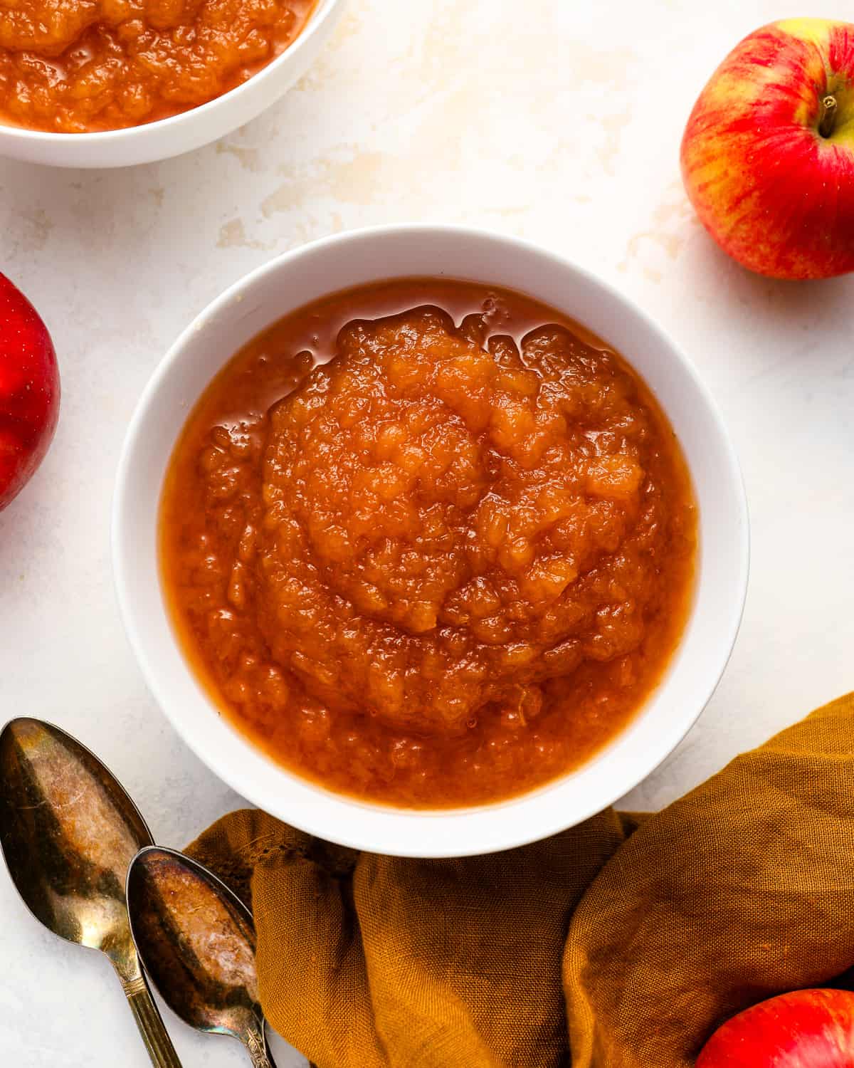 overhead view of a serving of applesauce in a white bowl.