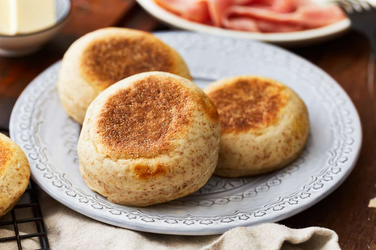 3 english muffins on a white plate.