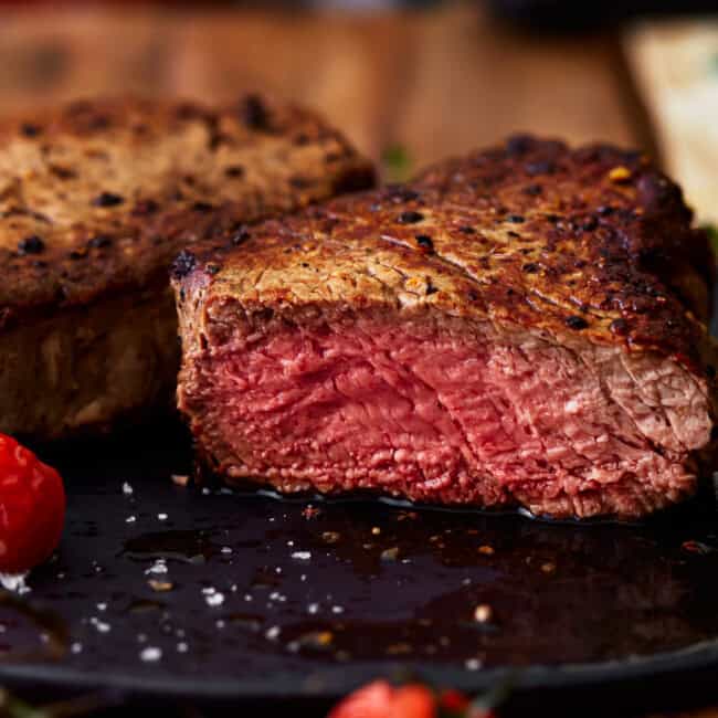 side view of a sliced filet mignon cooked to medium rare.