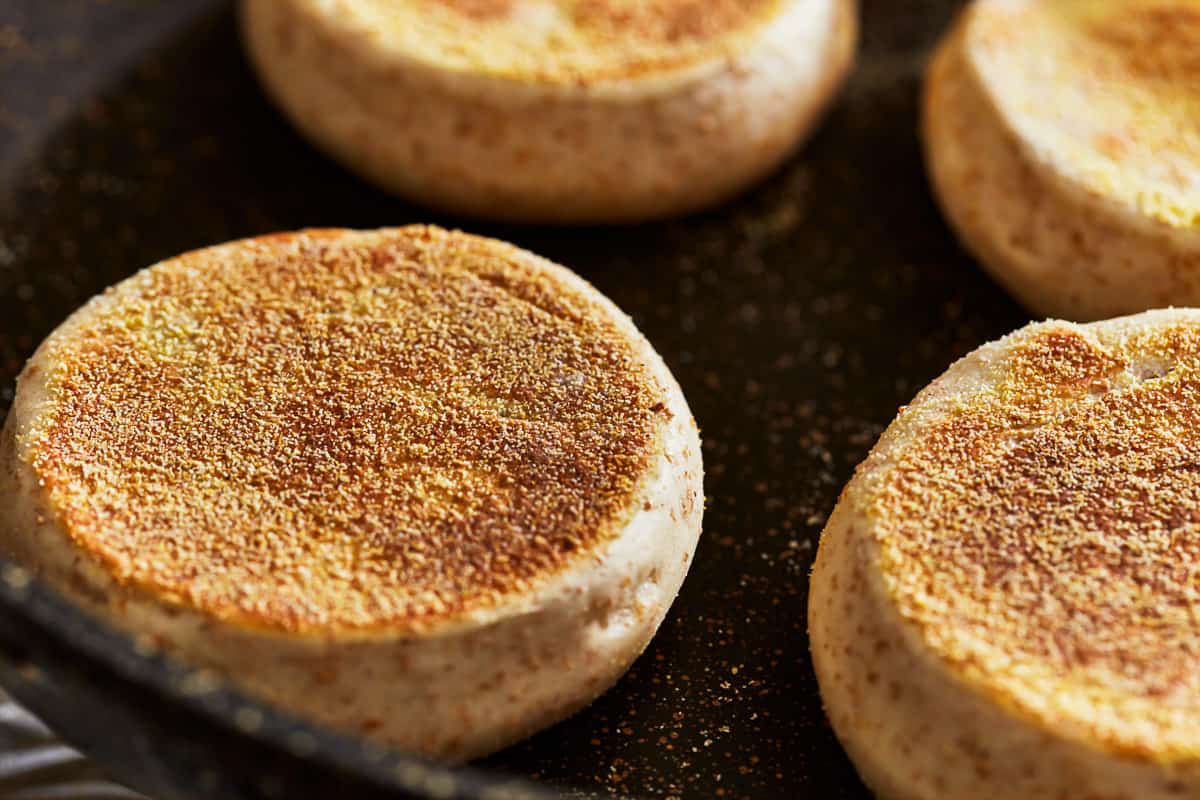 cooked english muffins in a pan.