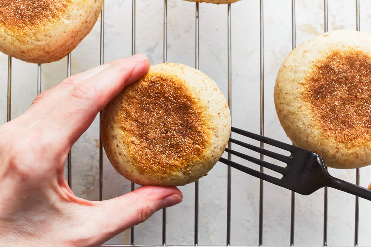 splitting an english muffin with a fork.