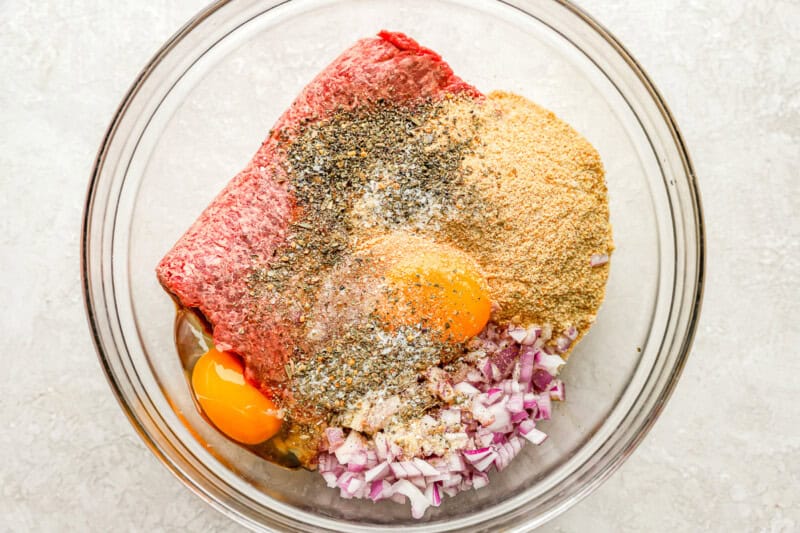 ingredients for meatloaf in a glass bowl.