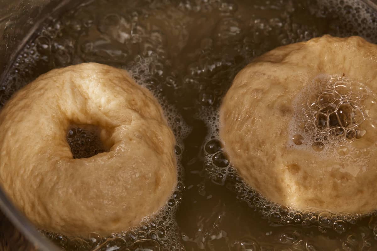 bagel dough boiling in an alkaline bath.