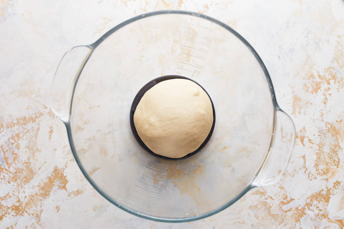 a smooth ball of dough in a glass bowl.