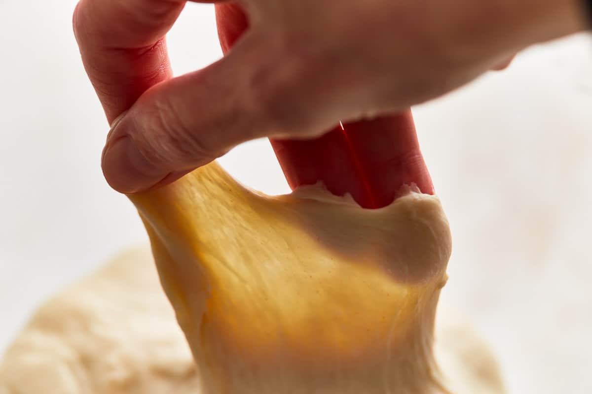 performing the windowpane test on bread dough.