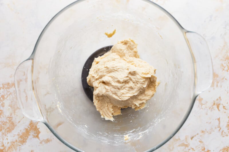 bread dough just barely formed in a glass bowl.