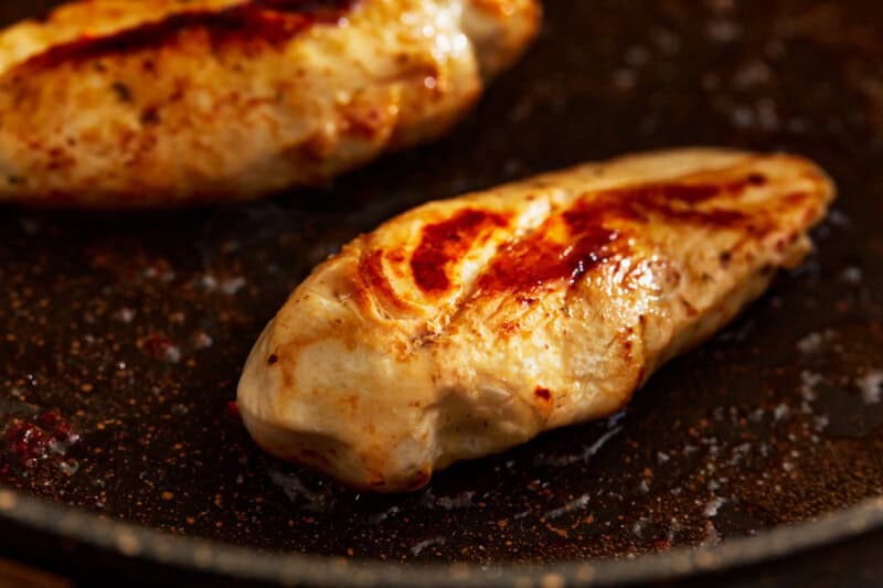 cooked chicken breasts in a pan.