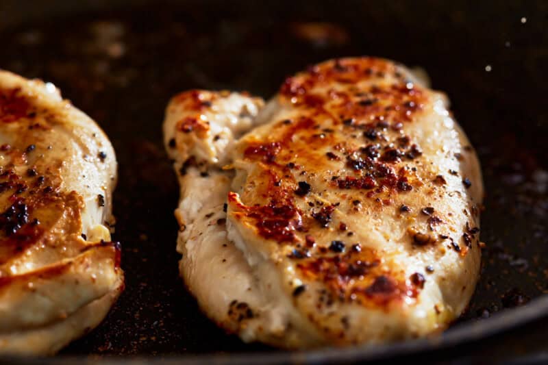 cooking chicken in a pan.