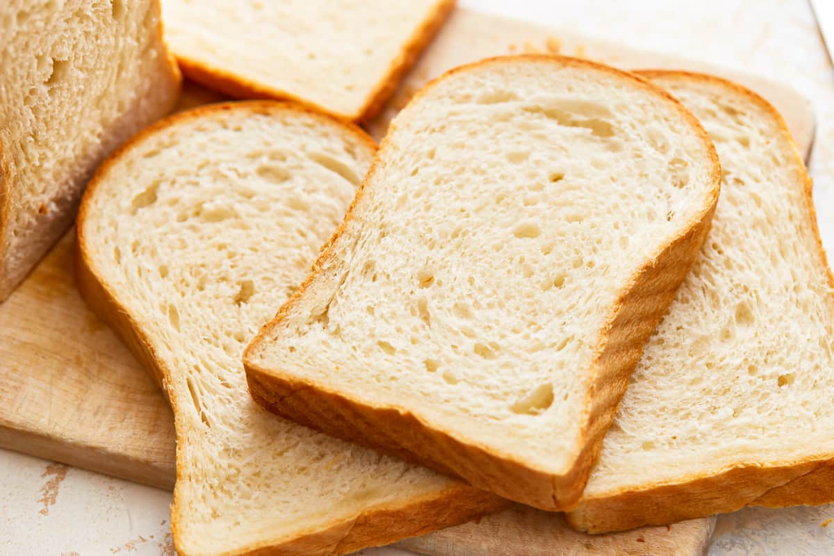 three-quarters view of scattered slices of white sandwich bread.