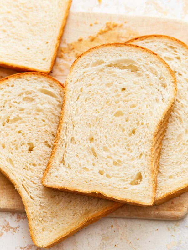 overhead view of scattered slices of white sandwich bread.