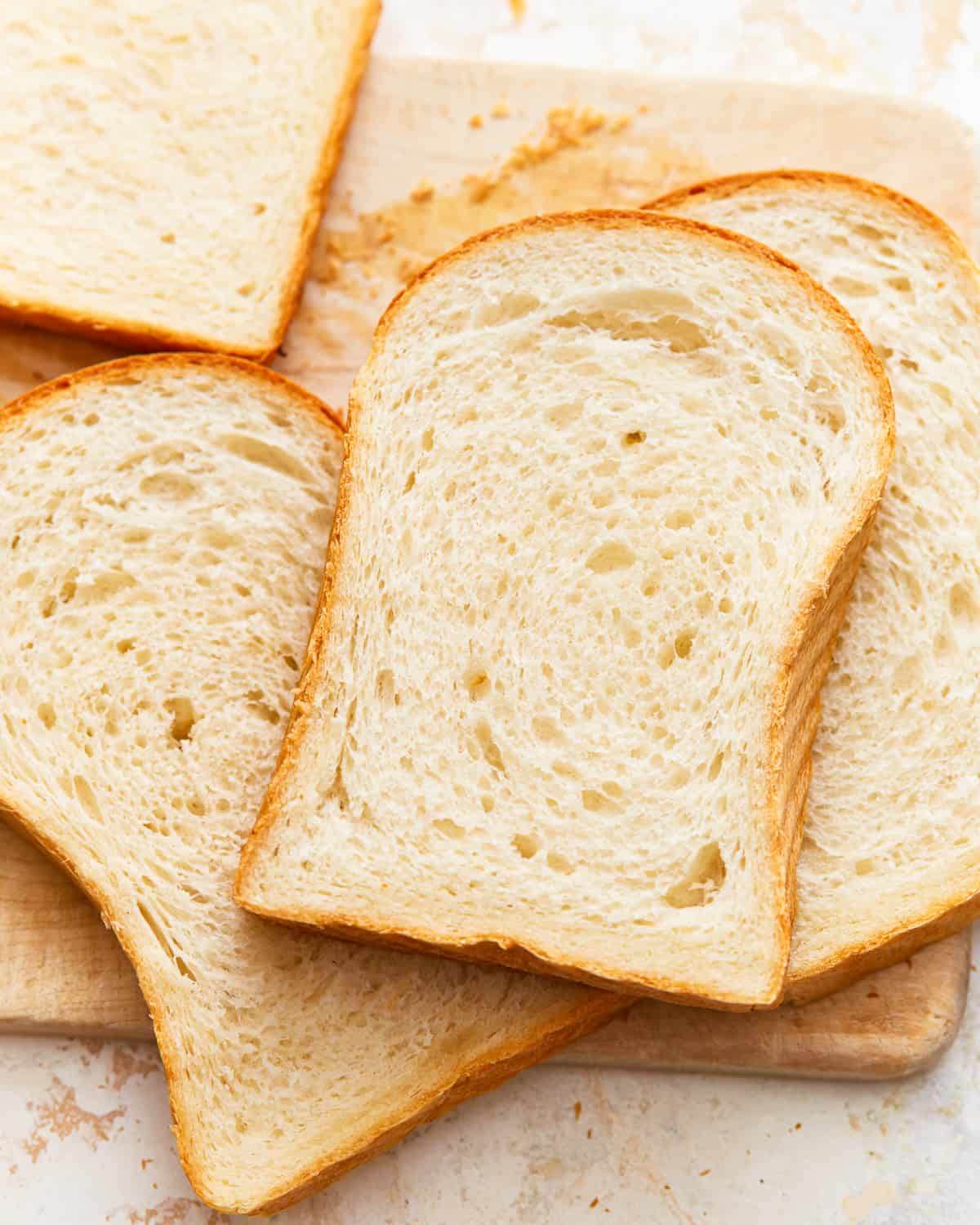 overhead view of scattered slices of white sandwich bread.