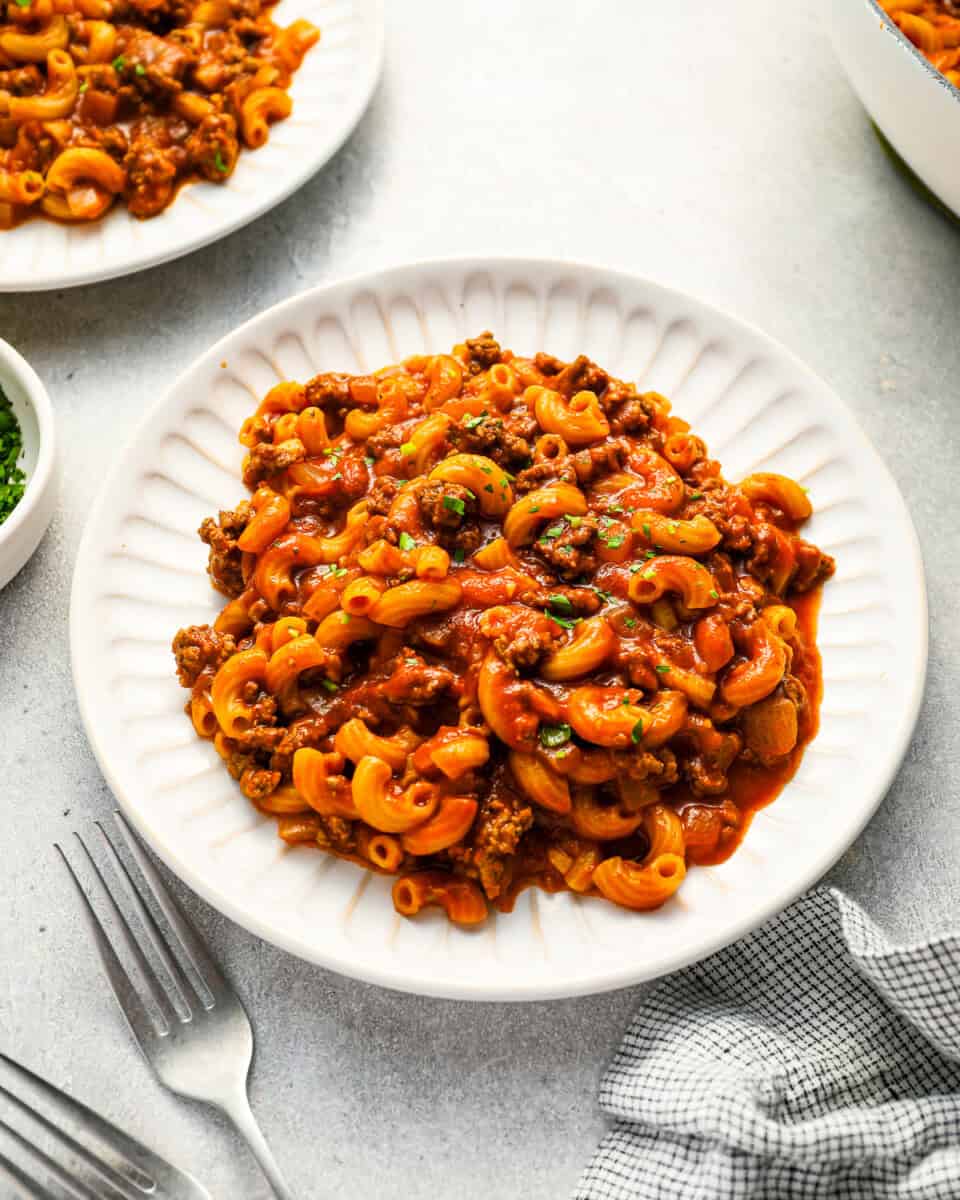 A serving of homemade Beefaroni casserole on a white plate.